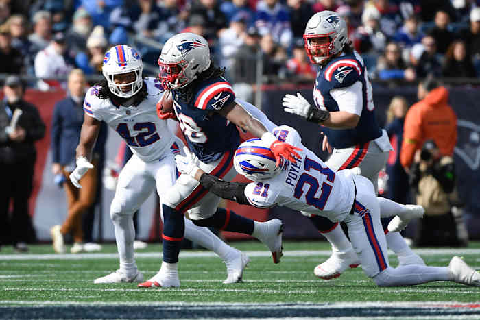 Bills safety Jordan Poyer attempts to bring down New England's Rhamondre Stevenson.